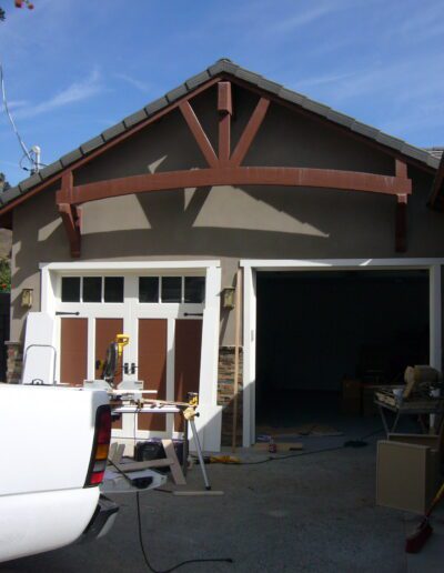 A white truck parked in front of a garage.